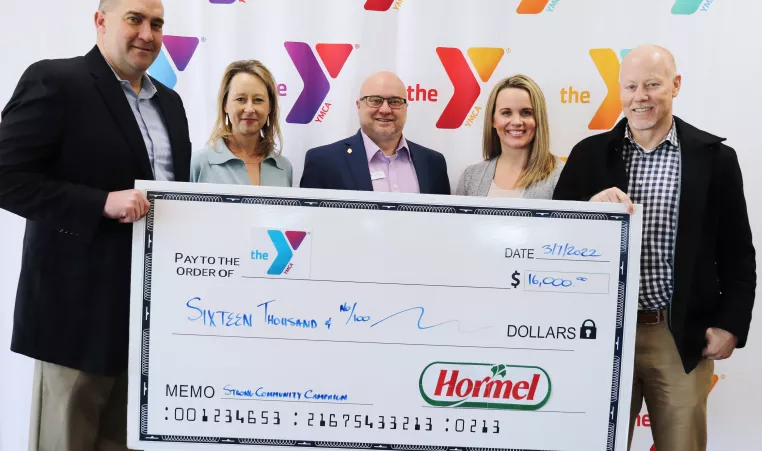 Check presentation photo: (left to right) Curtis Southard, Dold Foods Plant General Manager, Andrea Eliot, Greater Wichita YMCA Child Care and Camp Branch Director, David Foster, Richard A. DeVore South YMCA Branch Director, Hillary Hoesch, Greater Wichita YMCA Associate Vice President of Philanthropy, Ronn McMahon, Greater Wichita YMCA President and CEO